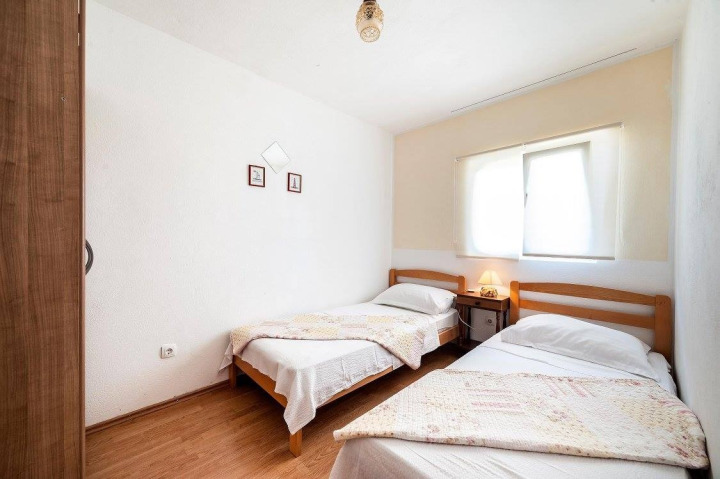 Cozy private room in a family senior care home, bright sunlight, Mediterranean decor